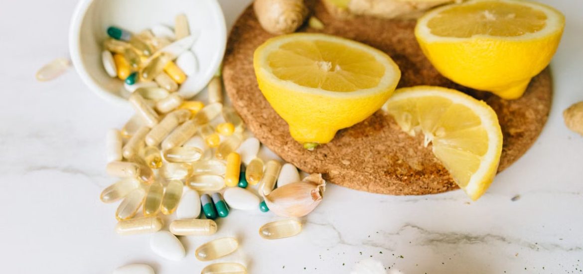 Sliced lemons and various supplements on a corkboard, symbolizing natural health remedies.